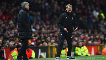 MANCHESTER, ENGLAND - JANUARY 15: Jurgen Klopp manager of Liverpool reacts as Jose Mourinho manager of Manchester United looks on during the Premier League match between Manchester United and Liverpool at Old Trafford on January 15, 2017 in Manchester, England. (Photo by Laurence Griffiths/Getty Images)