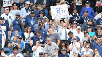 Sep 24, 2014; Bronx, NY, USA; Fans display signs for New York Yankees shortstop Derek Jeter (not pictured) during the third inning against the Baltimore Orioles at Yankee Stadium. Mandatory Credit: Anthony Gruppuso-USA TODAY Sports