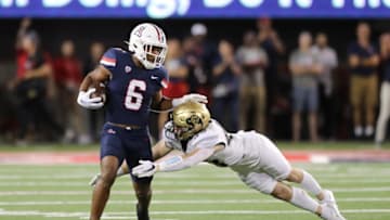 TUCSON, ARIZONA - OCTOBER 01: Running back Michael Wiley #6 of the Arizona Wildcats is tackled by safety Trevor Woods #43 of the Colorado Buffaloes during the first half of the NCAA football game between the Colorado Buffaloes and the Arizona Wildcats at Arizona Stadium on October 01, 2022 in Tucson, Arizona. (Photo by Rebecca Noble/Getty Images)
