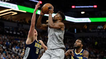 MINNEAPOLIS, MN - APRIL 11: Jimmy Butler #23 of the Minnesota Timberwolves shoots the ball against Nikola Jokic #15 and Paul Millsap #4 of the Denver Nuggets during the first quarter of the game on April 11, 2018 at the Target Center in Minneapolis, Minnesota. The Timberwolves defeated the Nuggets 112-106. NOTE TO USER: User expressly acknowledges and agrees that, by downloading and or using this Photograph, user is consenting to the terms and conditions of the Getty Images License Agreement. (Photo by Hannah Foslien/Getty Images)