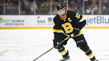 BOSTON, MA - DECEMBER 14: Patrice Bergeron #37 of the Boston Bruins skates with the puck in the third period of a game against the Vegas Golden Knights at TD Garden on December 14, 2021 in Boston, Massachusetts. (Photo by Adam Glanzman/Getty Images)