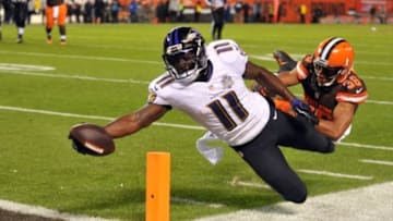 Nov 30, 2015; Cleveland, OH, USA; Baltimore Ravens wide receiver Kamar Aiken (11) stretches and scores a touchdown after a catch from Baltimore Ravens quarterback Matt Schaub (not pictured) as Cleveland Browns free safety K'Waun Williams (36) defends during the third quarter at FirstEnergy Stadium. Mandatory Credit: Ken Blaze-USA TODAY Sports