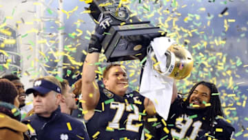 Dec 30, 2014; Nashville, TN, USA; Notre Dame Fighting Irish offensive lineman Nick Martin (72) and defensive lineman Sheldon Day (91) celebrate after winning the game against the LSU Tigers in the Music City Bowl at LP Field. Notre Dame won 31-28. Mandatory Credit: Christopher Hanewinckel-USA TODAY Sports