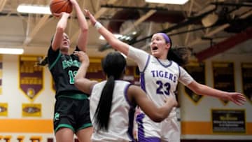 Feb 28, 2023; Westerville, Ohio, United States; Dublin Coffman's Tessa Grady (12) is defended by Pickerington Central's Berry Wallace (23) during the first quarter of the Division I girls basketball regional semifinals at Westerville North High School. Mandatory Credit: Joseph Scheller-The Columbus DispatchBasketball Girls Basketball Division I Regional Semifinals At Westerville North Tba At Tba