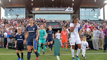 CARY, NORTH CAROLINA - AUGUST 18: Abby Erceg #6 of North Carolina Courage and Wendie Renard #3 of Olympique Lyonnais lead their teams on to the field prior to the start of the International Champions Cup championship match at WakeMed Soccer Park on August 18, 2019 in Cary, North Carolina. (Photo by Grant Halverson/International Champions Cup via Getty Images)