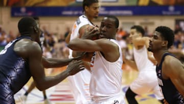 LAHAINA, HI - NOVEMBER 23: Cameron McGriff #12 of the Oklahoma State Cowboys pulls down a rebound between Akoy Agau #22 (l) and Rodney Pryor #23 of the Georgetown Hoyas during the second half of the Maui Invitational NCAA college basketball game at the Lahaina Civic Center on November 23, 2016 in Lahaina, Hawaii. (Photo by Darryl Oumi/Getty Images). Oklahoma State won the game 97-70.