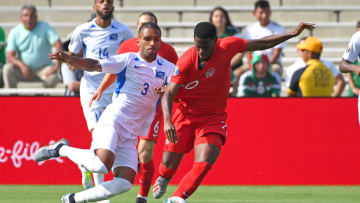 PASADENA, CA - JUNE 15: Jonathan David #20 of Canada and Jean-Sylvain Babin #3 of Martinique battle for the ball in the first half of the game at Rose Bowl on June 15, 2019 in Pasadena, California. (Photo by Jayne Kamin-Oncea/Getty Images)