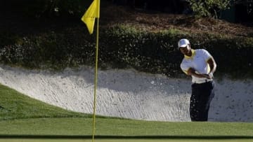 Apr 12, 2013; Augusta, GA, USA; Tiger Woods hits out of a bunker on the 12th hole during the second round of the 2013 The Masters golf tournament at Augusta National Golf Club. Mandatory Credit: Michael Madrid-USA TODAY Sports