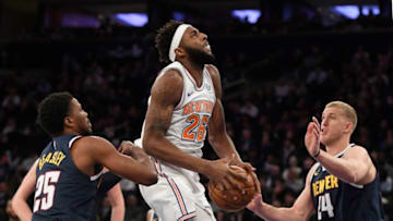 NEW YORK, NEW YORK - MARCH 22: Mitchell Robinson #26 of the New York Knicks attempts a basket against Malik Beasley #25 and Mason Plumlee #24 of the Denver Nuggets during the second half of the game at Madison Square Garden on March 22, 2019 in New York City. NOTE TO USER: User expressly acknowledges and agrees that, by downloading and or using this photograph, User is consenting to the terms and conditions of the Getty Images License Agreement. (Photo by Sarah Stier/Getty Images)