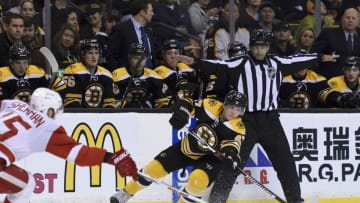 Apr 7, 2016; Boston, MA, USA; Boston Bruins defenseman Torey Krug (47) passes the puck past the reach of Detroit Red Wings center Riley Sheahan (15) during the second period at TD Garden. Mandatory Credit: Bob DeChiara-USA TODAY Sports