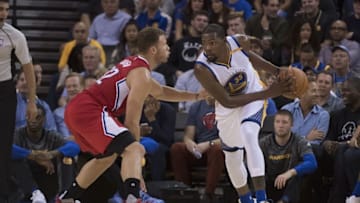 October 4, 2016; Oakland, CA, USA; Golden State Warriors forward Kevin Durant (35) controls the ball against Los Angeles Clippers forward Blake Griffin (32) during the second quarter at Oracle Arena. Mandatory Credit: Kyle Terada-USA TODAY Sports