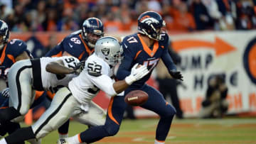 Dec 13, 2015; Denver, CO, USA; Oakland Raiders defensive end Khalil Mack (52) strip sacks Denver Broncos quarterback Brock Osweiler (17) in the end zone in the third quarter at Sports Authority Field at Mile High. Mandatory Credit: Ron Chenoy-USA TODAY Sports
