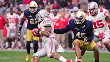 Jan 1, 2016; Glendale, AZ, USA; Ohio State Buckeyes running back Ezekiel Elliott (15) carries the ball as Notre Dame Fighting Irish defensive lineman Romeo Okwara (45) defends during the second half in the 2016 Fiesta Bowl at University of Phoenix Stadium. Mandatory Credit: Matt Kartozian-USA TODAY Sports