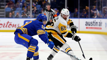 Oct 6, 2023; Buffalo, New York, USA; Buffalo Sabres center Peyton Krebs (19) tries to block a shoot in bt Pittsburgh Penguins defenseman Erik Karlsson (65) during the first period at KeyBank Center. Mandatory Credit: Timothy T. Ludwig-USA TODAY Sports
