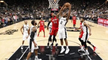 Mar 30, 2016; San Antonio, TX, USA; San Antonio Spurs small forward Kawhi Leonard (2) grabs a rebound as New Orleans Pelicans power forward Dante Cunningham (44) defends during the first half at AT&T Center. Mandatory Credit: Soobum Im-USA TODAY Sports