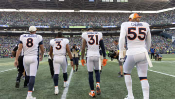 SEATTLE, WASHINGTON - SEPTEMBER 12: Denver Broncos Captains Russell Wilson #3, Brandon McManus #8, Justin Simmons #31 and Bradley Chubb #55 of the Denver Broncos walk out for the coin toss during a NFL game against the Seattle Seahawks at Lumen Field on September 12, 2022 in Seattle, Washington. (Photo by Tom Hauck/Getty Images)
