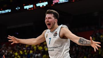 Real Madrid's Slovenian Luka Doncic (C-7) jumps over the barrier as the team celebrates their 85-80 win over Fenerbahce in the Euroleague Final Four finals basketball match between Real Madrid and Fenerbahce Dogus Istanbul at The Stark Arena in Belgrade on May 20, 2018. (Photo by Andrej ISAKOVIC / AFP) (Photo credit should read ANDREJ ISAKOVIC/AFP/Getty Images)
