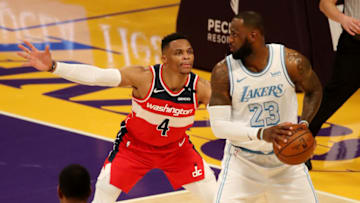 LOS ANGELES, CALIFORNIA - FEBRUARY 22: Russell Westbrook #4 of the Washington Wizards guards LeBron James #23 of the Los Angeles Lakers during the fourth quarter at Staples Center on February 22, 2021 in Los Angeles, California. NOTE TO USER: User expressly acknowledges and agrees that, by downloading and or using this photograph, User is consenting to the terms and conditions of the Getty Images License Agreement. (Photo by Katelyn Mulcahy/Getty Images)