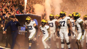 INDIANAPOLIS, INDIANA - DECEMBER 02: Head coach Jim Harbaugh of the Michigan Wolverines leads his team onto the field prior to the game against the Iowa Hawkeyes during the Big Ten Championship at Lucas Oil Stadium on December 02, 2023 in Indianapolis, Indiana. (Photo by Justin Casterline/Getty Images)