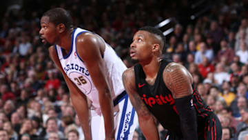 PORTLAND, OR - MARCH 9: Kevin Durant #35 of the Golden State Warriors and Damian Lillard #0 of the Portland Trail Blazers look on during the game between the two teams on March 9, 2018 at the Moda Center Arena in Portland, Oregon. NOTE TO USER: User expressly acknowledges and agrees that, by downloading and or using this photograph, user is consenting to the terms and conditions of the Getty Images License Agreement. Mandatory Copyright Notice: Copyright 2018 NBAE (Photo by Sam Forencich/NBAE via Getty Images)