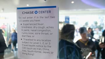 SAN FRANCISCO, CALIFORNIA - MARCH 07: A health warning sign is posted at the entrance to Chase Center before the game between the Golden State Warriors and the Philadelphia 76ers at Chase Center on March 07, 2020 in San Francisco, California. NOTE TO USER: User expressly acknowledges and agrees that, by downloading and/or using this photograph, user is consenting to the terms and conditions of the Getty Images License Agreement. (Photo by Lachlan Cunningham/Getty Images)