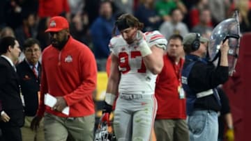 Jan 1, 2016; Glendale, AZ, USA; Ohio State Buckeyes defensive lineman Joey Bosa (97) leaves the game after being ejected for a targeting penalty during the first half of the 2016 Fiesta Bowl against the Notre Dame Fighting Irish at University of Phoenix Stadium. Mandatory Credit: Joe Camporeale-USA TODAY Sports