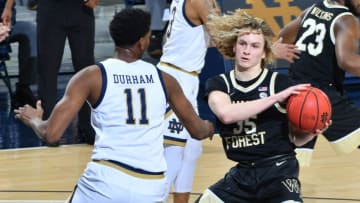Feb 2, 2021; South Bend, Indiana, USA; Wake Forest Demon Deacons forward Ismael Masoud (25) dribbles as Notre Dame Fighting Irish forward Juwan Durham (11) defends in the first half at the Purcell Pavilion. Mandatory Credit: Matt Cashore-USA TODAY Sports