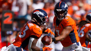 DENVER, COLORADO - SEPTEMBER 18: Russell Wilson #3 of the Denver Broncos hands off the ball to Javonte Williams #33 of the Denver Broncos in the first quarter of the game against the Houston Texans at Empower Field At Mile High on September 18, 2022 in Denver, Colorado. (Photo by Justin Edmonds/Getty Images)