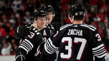 Jesper Bratt #63 of the New Jersey Devils is congratulated by teammates Damon Severson #28 and Pavel Zacha #37 after he scored during the second period against the Philadelphia Flyers at Prudential Center on December 08, 2021 in Newark, New Jersey. Tonight the New Jersey Devils are wearing their newly designed third jersey. (Photo by Elsa/Getty Images)