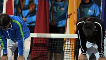 Novak Djokovic of Serbia (R) and Rafael Nadal of Spain (L) look exhausted before the start of the awards ceremony following the men's final match on day 14 of the 2012 Australian Open tennis tournament early on January 30, 2012. Djokovic won the championship 5-7, 6-4, 6-2, 6-7, 7-5. IMAGE STRICTLY RESTRICTED TO EDITORIAL USE - STRICTLY NO COMMERCIAL USE AFP PHOTO / PAUL CROCK (Photo credit should read PAUL CROCK/AFP via Getty Images)