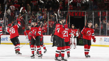 NEWARK, NJ - DECEMBER 31: The New Jersey Devils salute the fans after defeating the Boston Bruins in a shootout at the Prudential Center on December 31, 2019 in Newark, New Jersey. The Devils defeated the Bruins 3-2. (Photo by Andy Marlin/NHLI via Getty Images)