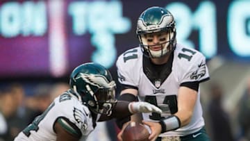 Nov 6, 2016; East Rutherford, NJ, USA; Philadelphia Eagles quarterback Carson Wentz (11) hands the ball off to Eagles running back Kenjon Barner (34) during the second half at MetLife Stadium. The Giants won 28-23. Mandatory Credit: William Hauser-USA TODAY Sports
