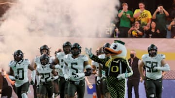 LAS VEGAS, NEVADA - DECEMBER 03: Defensive end Kayvon Thibodeaux #5 of the Oregon Ducks and the Ducks mascot The Duck lead the team onto the field for the Pac-12 Conference championship game against the Utah Utes at Allegiant Stadium on December 3, 2021 in Las Vegas, Nevada. The Utes defeated the Ducks 38-10. (Photo by Ethan Miller/Getty Images)