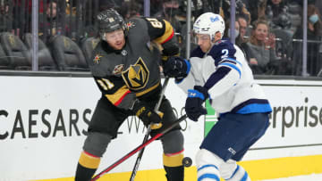 Jan 2, 2022; Las Vegas, Nevada, USA; Winnipeg Jets defenseman Dylan DeMelo (2) deflects a centering pass made by Vegas Golden Knights center Jonathan Marchessault (81) during the second period at T-Mobile Arena. Mandatory Credit: Stephen R. Sylvanie-USA TODAY Sports