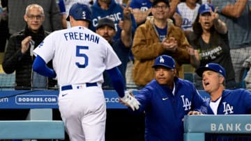 Apr 18, 2022; Los Angeles, California, USA; Los Angeles Dodgers first baseman Freddie Freeman (5) is congratulated by manager Dave Roberts (30) after hitting a home run in the first inning against the Atlanta Braves at Dodger Stadium. Mandatory Credit: Richard Mackson-USA TODAY Sports