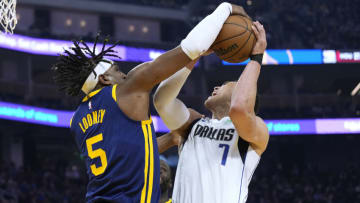 SAN FRANCISCO, CALIFORNIA - FEBRUARY 04: Dwight Powell #7 of the Dallas Mavericks has his shot blocked but gets fouled on the play by Kevon Looney #5 of the Golden State Warriors during the first quarter of the game at Chase Center on February 04, 2023 in San Francisco, California. NOTE TO USER: User expressly acknowledges and agrees that, by downloading and or using this photograph, User is consenting to the terms and conditions of the Getty Images License Agreement. (Photo by Thearon W. Henderson/Getty Images)