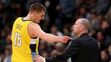 DENVER, CO - JANUARY 27: Nikola Jokic #15 of the Denver Nuggets confers with head coach Michael Malone while playing the Dallas Mavericks at the Pepsi Center on January 27, 2018 in Denver, Colorado. NOTE TO USER: User expressly acknowledges and agrees that, by downloading and or using this photograph, User is consenting to the terms and conditions of the Getty Images License Agreement. (Photo by Matthew Stockman/Getty Images)
