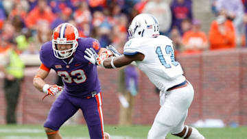 CLEMSON, SC - NOVEMBER 23: Daniel Rodriguez #83 of the Clemson Tigers tries to break past Cody Richardson #13 of the Citadel Bulldogs during the game at Memorial Stadium on November 23, 2013 in Clemson, South Carolina. (Photo by Tyler Smith/Getty Images)