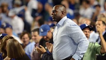 October 14, 2013; Los Angeles, CA, USA; Part owner Magic Johnson watches game action during the fifth inning as the Los Angeles Dodgers play against the St. Louis Cardinals in game three of the National League Championship Series baseball game at Dodger Stadium. Mandatory Credit: Jayne Kamin-Oncea-USA TODAY Sports