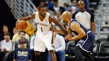 Apr 14, 2014; New Orleans, LA, USA; New Orleans Pelicans forward Tyreke Evans (1) is guarded by Oklahoma City Thunder guard Derek Fisher (6) during the second quarter of a game at Smoothie King Center. Mandatory Credit: Derick E. Hingle-USA TODAY Sports