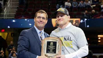CLEVELAND, OH - MARCH 17: Head coach Cael Sanderson of the Penn State Nittany Lions is presented with the Division I Coach of the Year award during the awards ceremony of the NCAA Photos via Getty Imagess via Getty Images Wrestling Championships on March 17, 2018 at QuickenLoans Arena in Cleveland, Ohio. (Photo by Hunter Martin/Getty Images) *** Local Caption *** Cael Sanderson