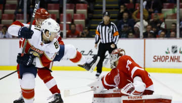 Dec 1, 2016; Detroit, MI, USA; Florida Panthers center Jonathan Marchessault (81) and Detroit Red Wings defenseman Mike Green (25) battle for the puck in front of goalie Petr Mrazek (34) during the third period at Joe Louis Arena. Florida won 2-1 in overtime. Mandatory Credit: Rick Osentoski-USA TODAY Sports