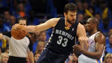 Apr 19, 2014; Oklahoma City, OK, USA; Memphis Grizzlies center Marc Gasol (33) handles the ball against Oklahoma City Thunder forward Serge Ibaka (9) during the third quarter in game one during the first round of the 2014 NBA Playoffs at Chesapeake Energy Arena. Mandatory Credit: Mark D. Smith-USA TODAY Sports