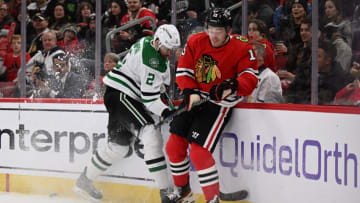 Mar 2, 2023; Chicago, Illinois, USA; Dallas Stars defenseman Jani Hakanpaa (2) and Chicago Blackhawks forward Joey Anderson (15) battle for control of the puck in the second period at United Center. Mandatory Credit: Jamie Sabau-USA TODAY Sports
