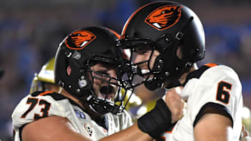 PASADENA, CALIFORNIA - OCTOBER 05: Jake Luton #6 of the Oregon State Beavers celebrates his touchdown with Blake Brandel #73, to take a 48-31 lead over the UCLA Bruins, during the fourth quarter at the Rose Bowl on October 05, 2019 in Pasadena, California. (Photo by Harry How/Getty Images)