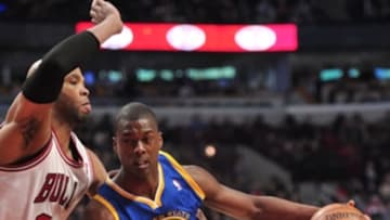 Feb 26, 2014; Chicago, IL, USA; Golden State Warriors small forward Harrison Barnes (40) is defended by Chicago Bulls power forward Taj Gibson (22) during the second half at the United Center. The Bulls beat the Warriors 103-83. Mandatory Credit: Rob Grabowski-USA TODAY Sports
