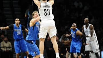 Jan 24, 2014; Brooklyn, NY, USA; Brooklyn Nets power forward Mirza Teletovic (33) shoots a three point shot over Dallas Mavericks power forward Dirk Nowitzki (41) during the first half at Barclays Center. Mandatory Credit: Joe Camporeale-USA TODAY Sports