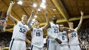 Feb 20, 2016; Villanova, PA, USA; Villanova Wildcats seniors Patrick Farrell (20) and Henry Lowe (0) and Daniel Ochefu (23) and Ryan Arcidiacono (15) and Kevin Rafferty (52) react to the student section after a victory against the Butler Bulldogs on senior day at The Pavilion. The Villanova Wildcats won 77-67. Mandatory Credit: Bill Streicher-USA TODAY Sports