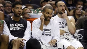 Mar 15, 2015; San Antonio, TX, USA; San Antonio Spurs players (from left to right) Tim Duncan, and Tony Parker, and Manu Ginobili watch on the bench during the first half against the Minnesota Timberwolves at AT&T Center. Mandatory Credit: Soobum Im-USA TODAY Sports