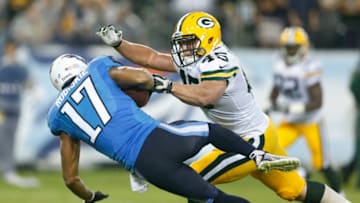 NASHVILLE, TN - AUGUST 09: Brian Robiskie #17 of the Tennessee Titans makes a 38-yard reception behind Jake Doughty #45 of the Green Bay Packers in the fourth quarter of an NFL preseason game at LP Field on August 9, 2014 in Nashville, Tennessee. The Titans won 20-16. (Photo by Joe Robbins/Getty Images)